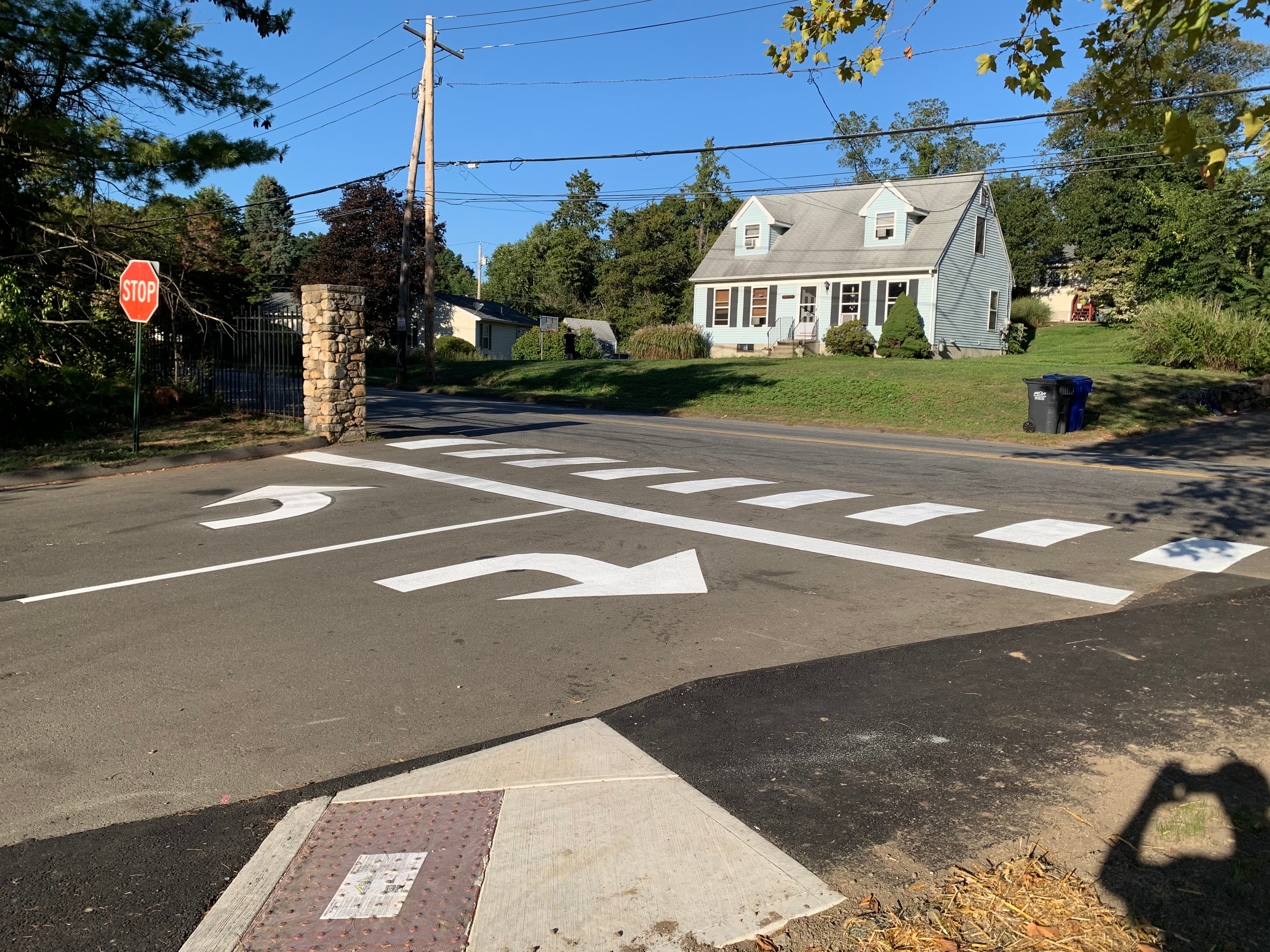 Yellow directional arrows and white crosswalk painted at Fairfield CT municipal lot