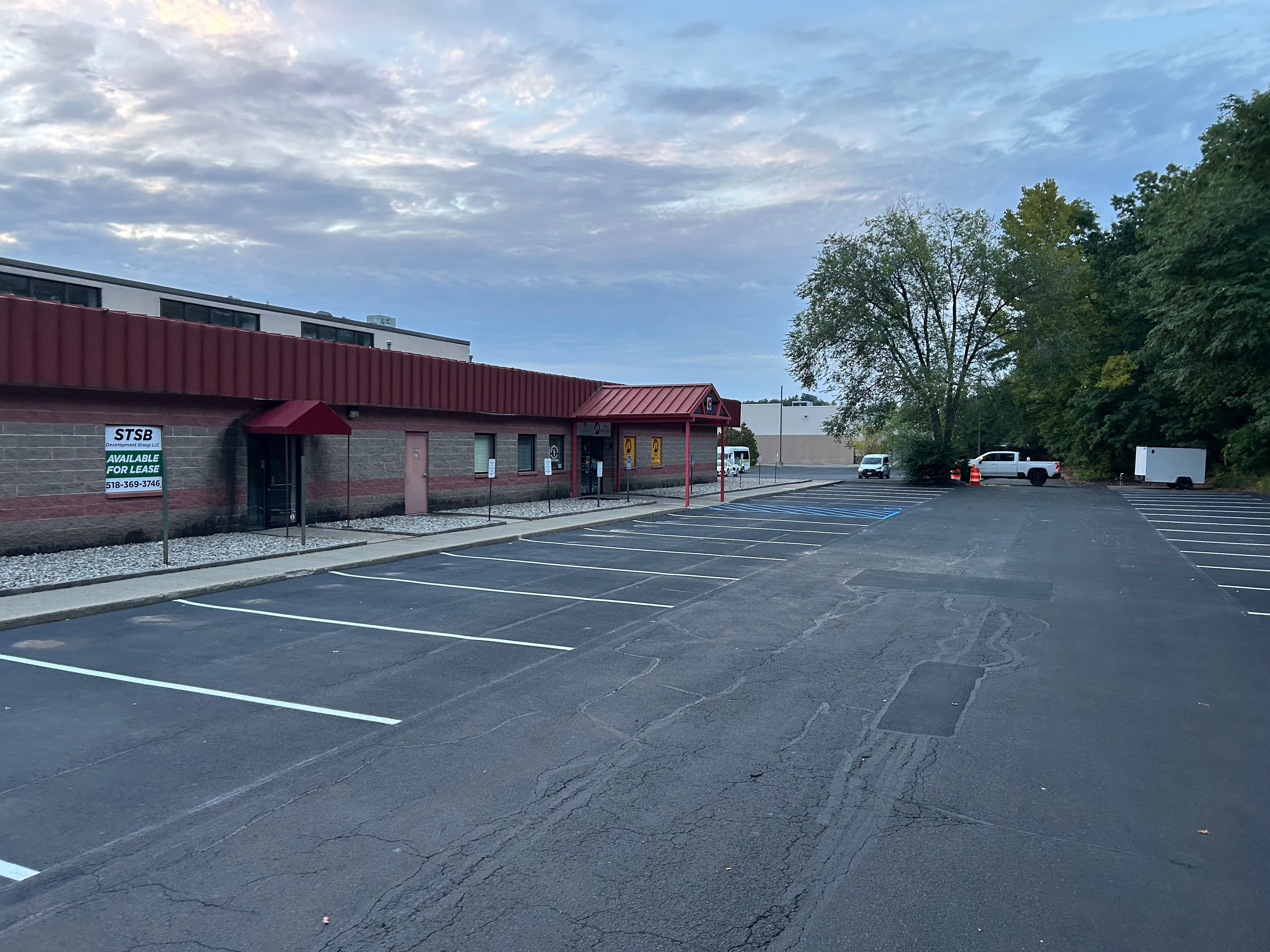 Commercial plaza entrance alternate angle showing clean white parking stall lines