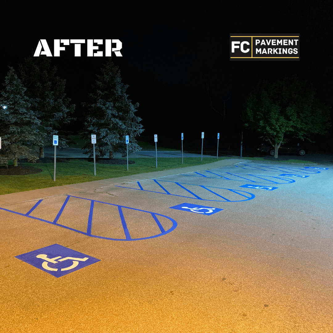 ADA handicap parking stalls after restriping with fresh blue hatching and stencils