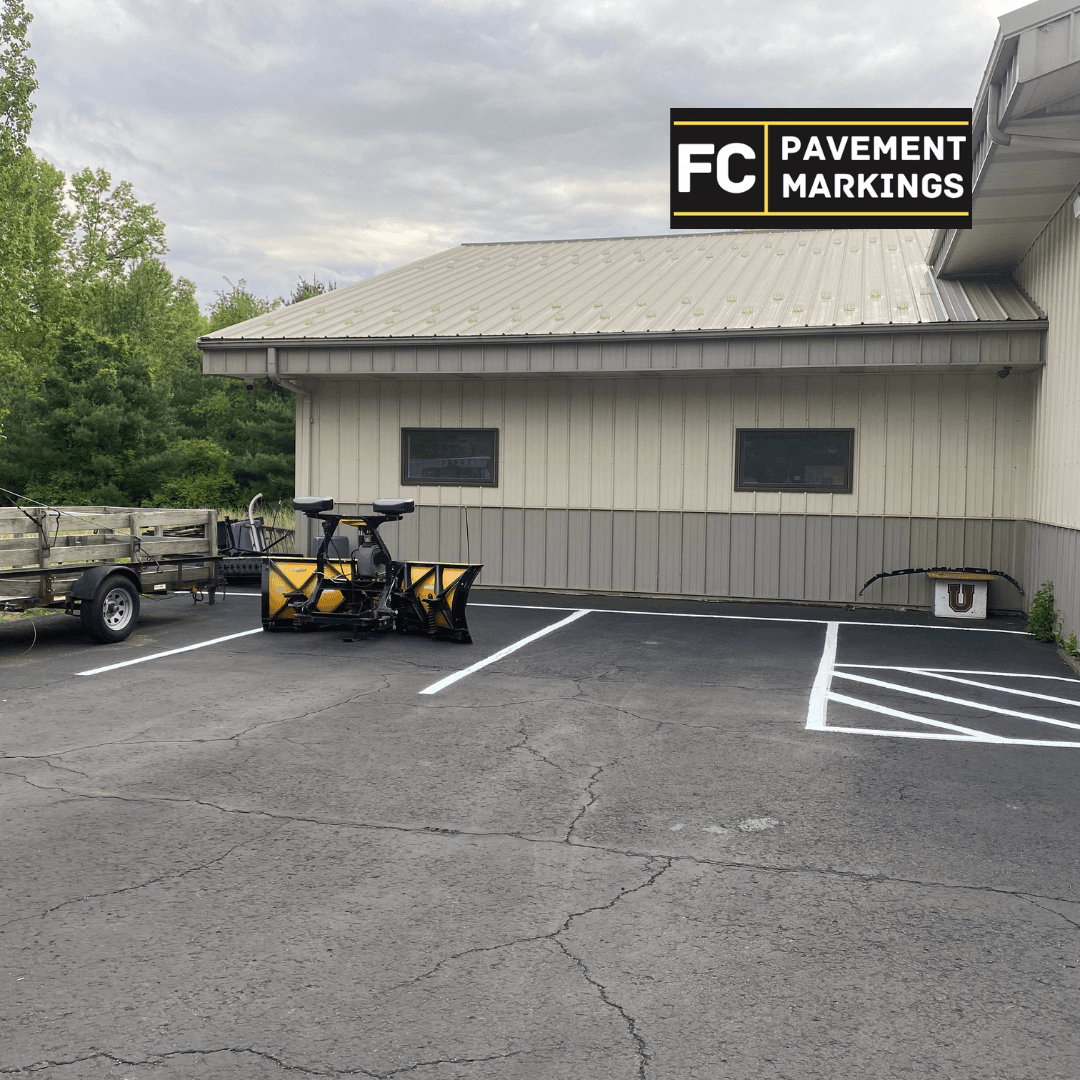 Commercial lot after line striping showing plow-ready markings