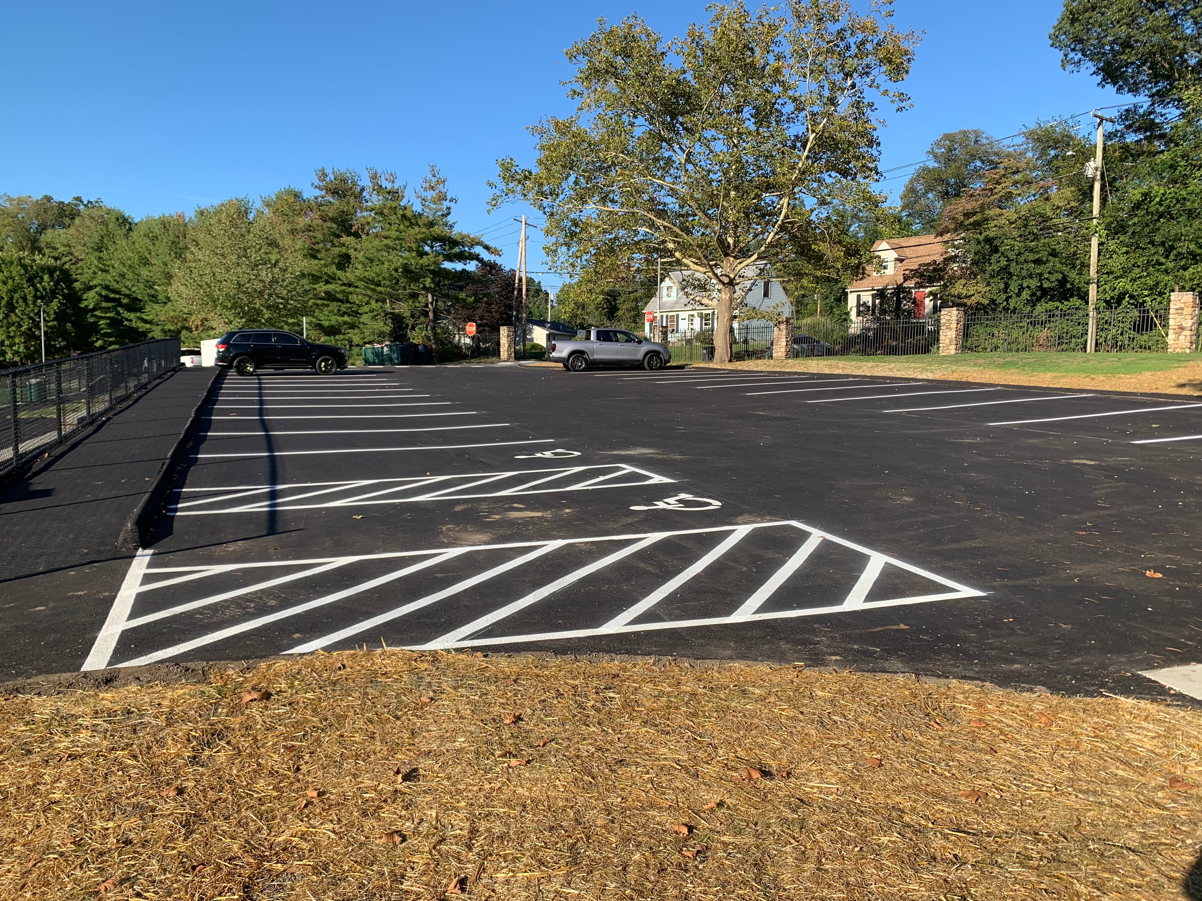 Full layout municipal parking lot in Fairfield, CT with ADA stalls, crosswalks, directional arrows, and stop bars Full layout municipal parking lot in Fairfield, CT with ADA stalls, crosswalks, directional arrows, and stop bars